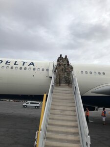 Soldiers from the 333rd Military Police Company, based in Freeport, Illinois, deplane at Fort Bliss, Texas, July 1 after completing a year-long overseas deployment.