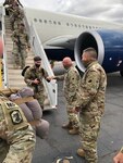 Soldiers from the 333rd Military Police Company, based in Freeport, Illinois, receive a fist bump welcome home from Maj. Gen. Michael Zerbonia, Illinois Army National Guard Commander and Assistant Adjutant General – Army, as they deplane at Fort Bliss, Texas, following a year-long overseas deployment.