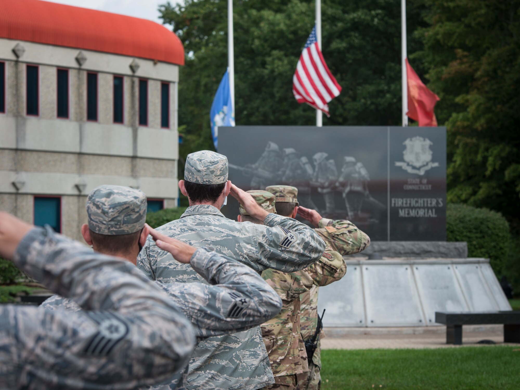 Firefighters from the 103rd Civil Engineer Squadron render a salute during a 9/11 memorial ceremony at the State of Connecticut Firefighter’s Memorial, Windsor Locks, Conn. Sept. 11, 2020. Firefighters from the Connecticut National Guard joined Connecticut Fire Academy staff and recruits to remember the first responders who made the ultimate sacrifice on September 11, 2001. (U.S. Air National Guard photo by Staff Sgt. Steven Tucker)