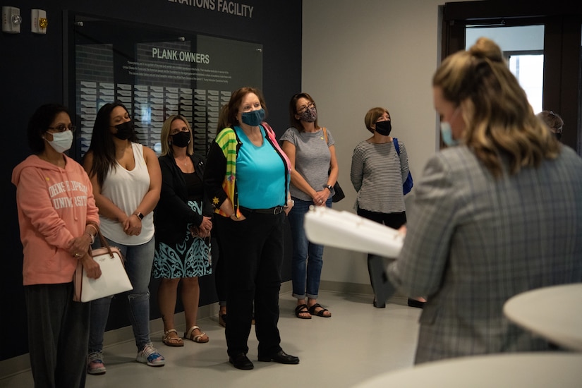 Joint Base Andrews military spouses listen to a historical briefing by Mattea Sanders, 316th Wing historian, about the Helicopter Operations Facility during the “Windshield Tour” on JBA, Oct. 23, 2020.