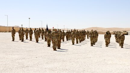 Soldiers assigned to Company C, 2nd Battalion, 130th Infantry Regiment, based in Litchfield, Illinois, stand in formation waiting for the patching ceremony to begin.