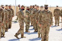 Senior non-commissioned officers with Headquarters and Headquarters Company, 2nd Battalion, 130th Infantry Regiment, based in Marion, Illinois, present the Soldiers with combat patches.