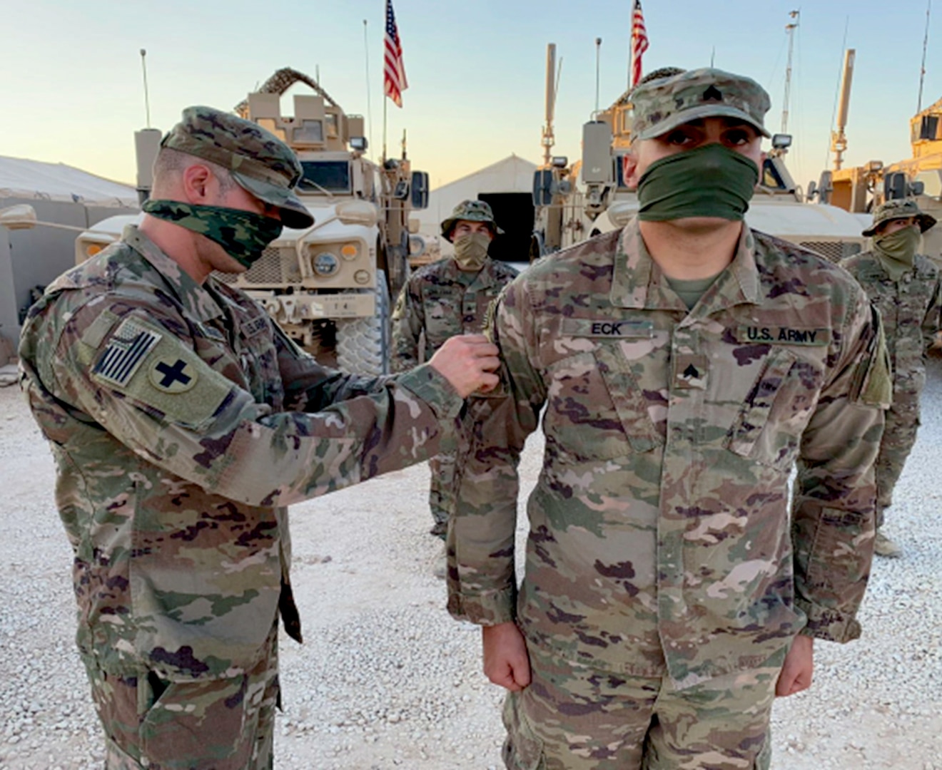 Staff Sgt. Alexander Koroyanis, of Loda, Illinois, squad leader for Company B, 2nd Battalion, 130th Infantry Regiment, based in Effingham, Illinois, presents Sgt. Joseph Eck, of Owensville, Indiana, with his combat patch during the ceremony.