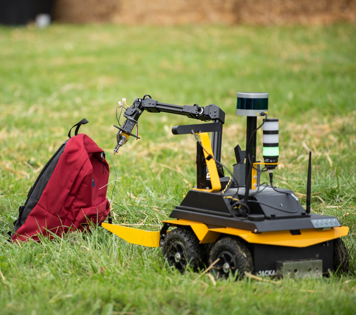 Goose Buster’s robot attempts to neutralize an IED represented by a red backpack.