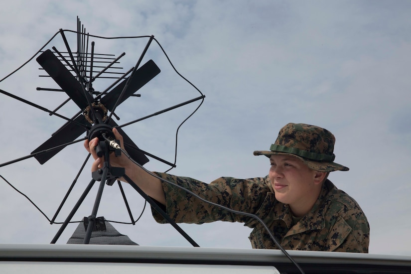 A woman sets up a satellite antenna.