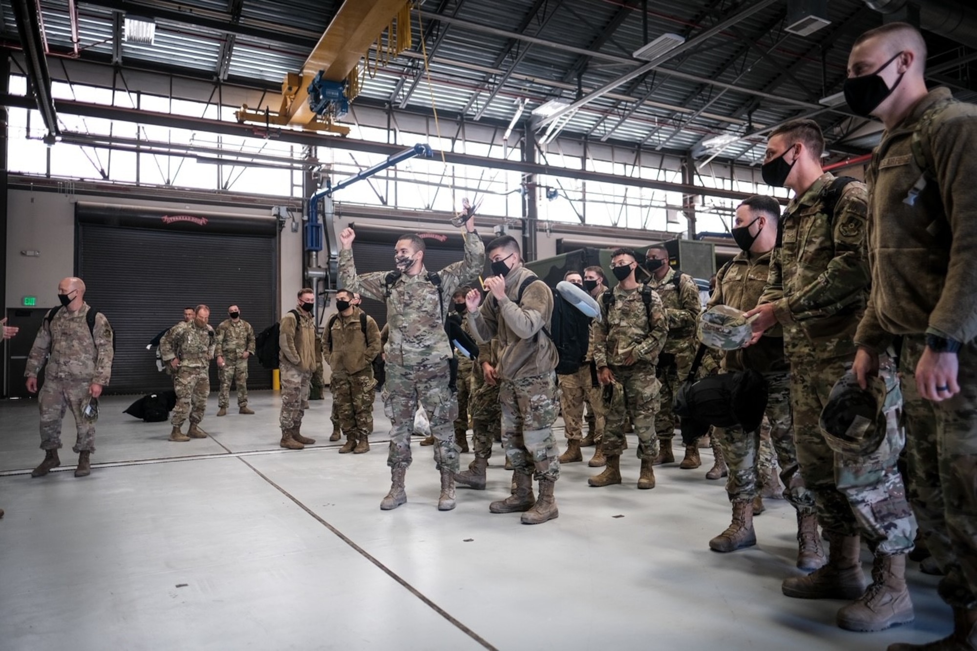 Airmen assigned to the 729th Air Control Squadron father in a hangar after returning home.