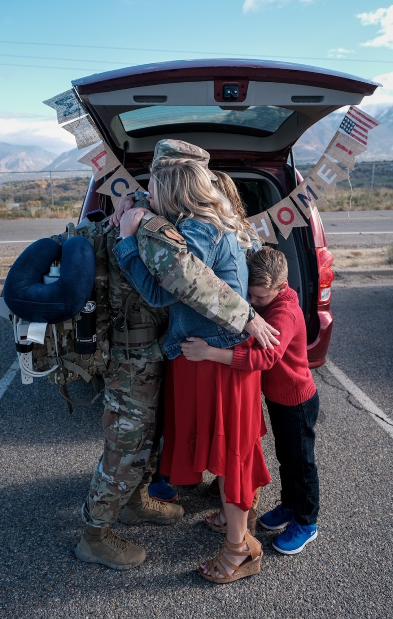 An Airman assigned to the 729th Air Control Squadron hugs his family members upon his returns home.
