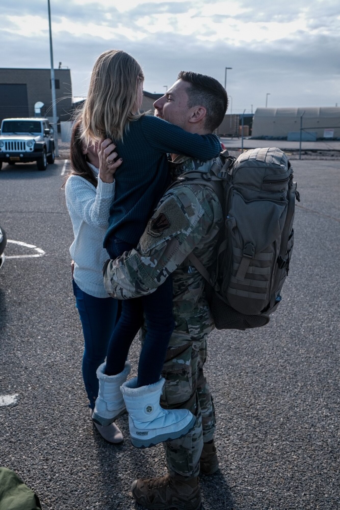 An Airman assigned to the 729th Air Control Squadron hugs a family member upon his returns home.