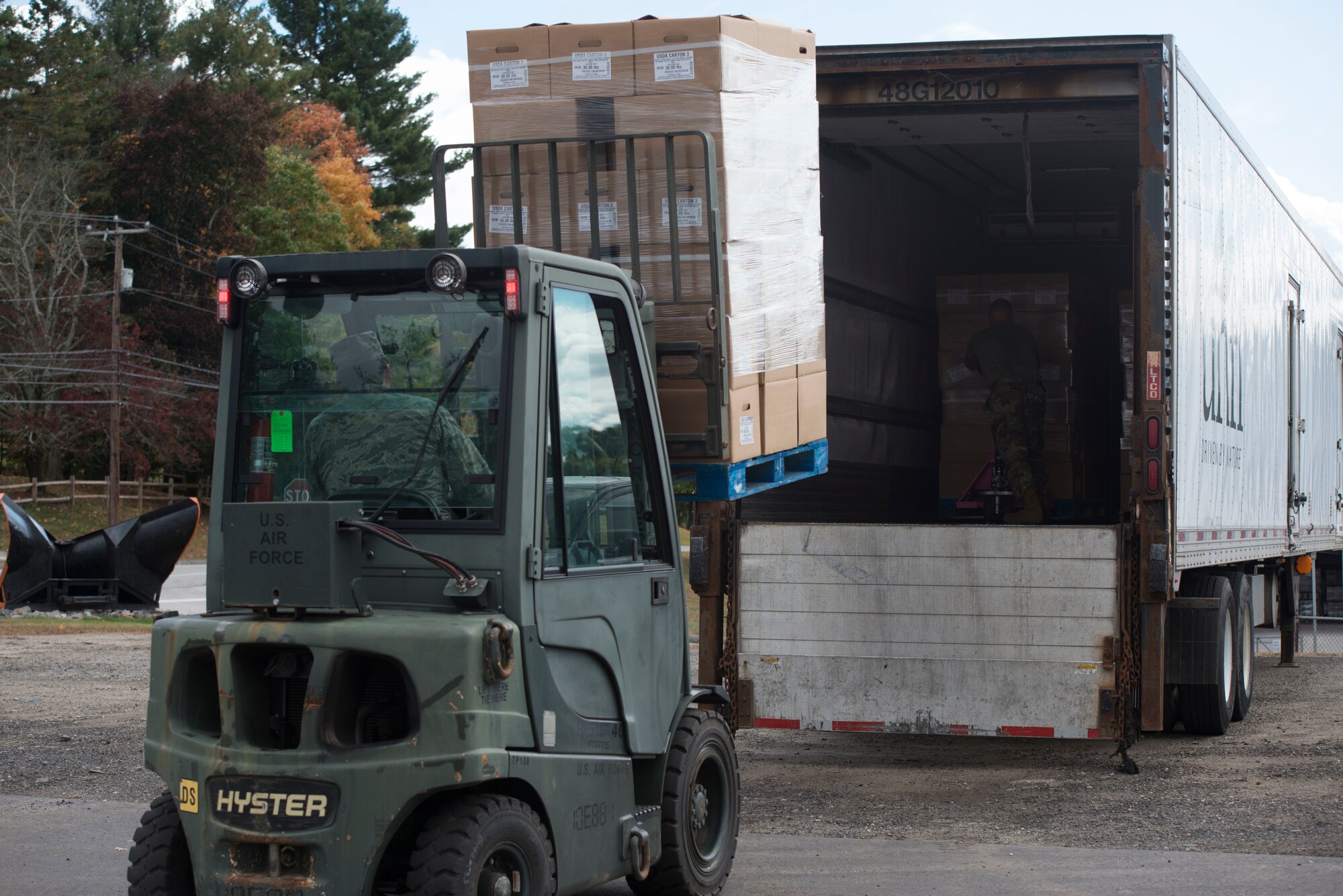 Members of the Connecticut Air National Guard, 103rd Logistics Readiness Squadron load Farmers to Families Food Boxes onto a truck at the Killingly Highway Department in Dayville, Connecticut, September 30, 2020. The boxes were going to be  delivered to homes and food pantries. (U.S. Air National Guard photo by Tech. Sgt. Tamara R. Dabney)