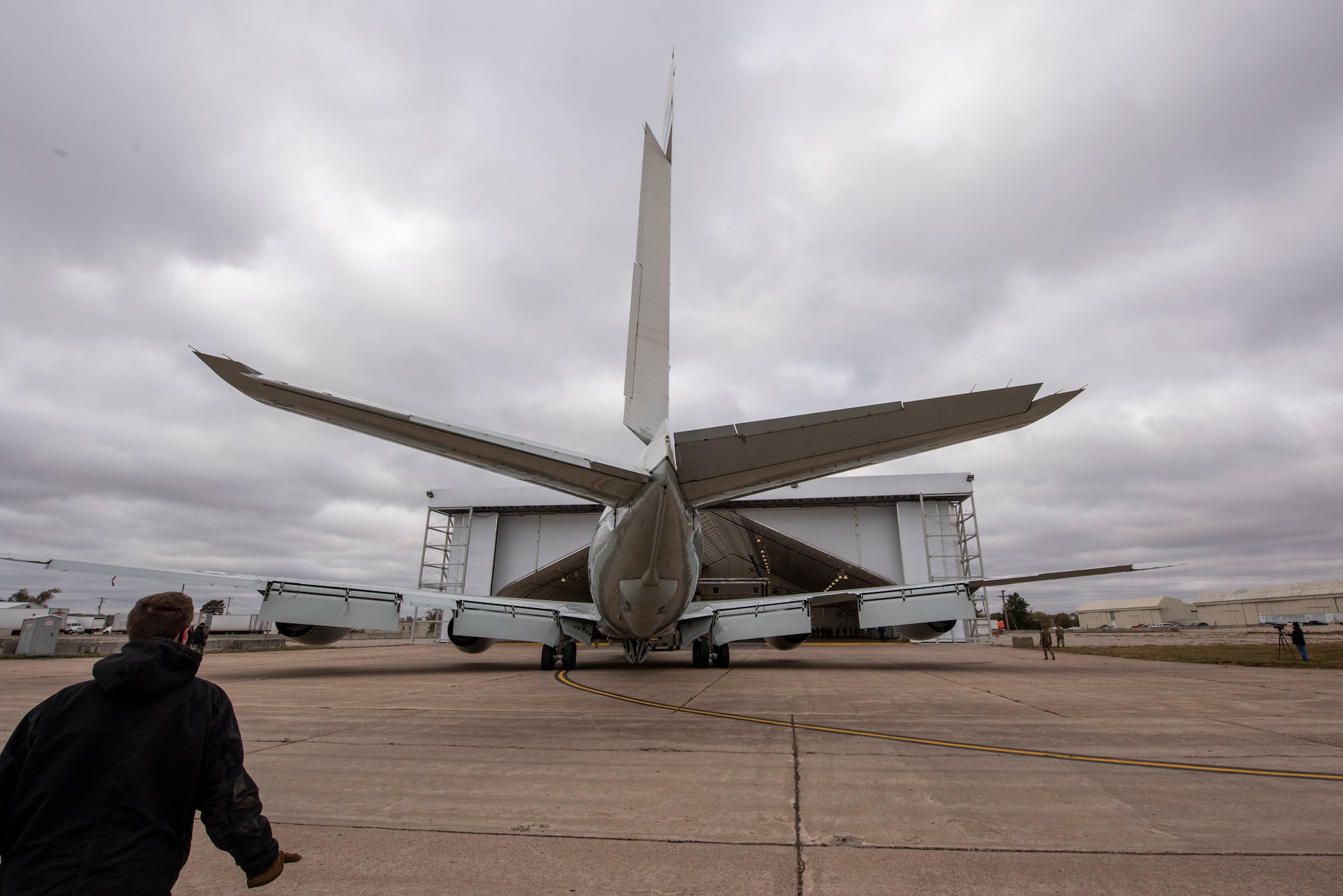 An Airman watches the tail of an aircraft as it is towed into a newly constructed hangar at Lincoln Airport during a proof of concept exercise Oct. 23, 2020.