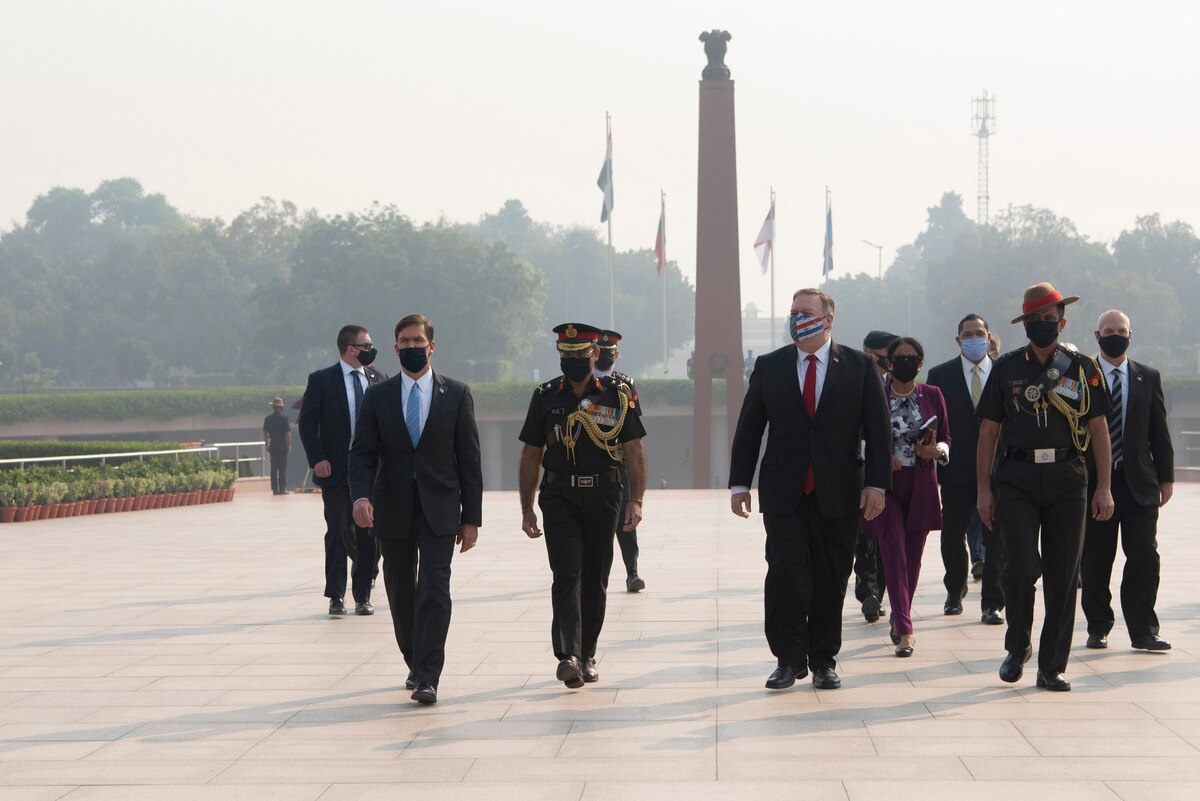 Defense Secretary Dr. Mark T. Esper and Secretary of State Michael R. Pompeo walk with other officials at an outdoor monument.