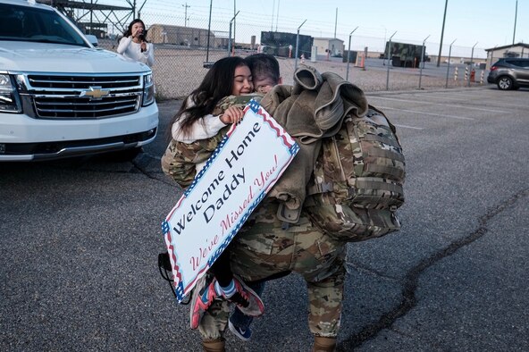 An Airman assigned to the 729th Air Control Squadron hugs a family member upon his return home.
