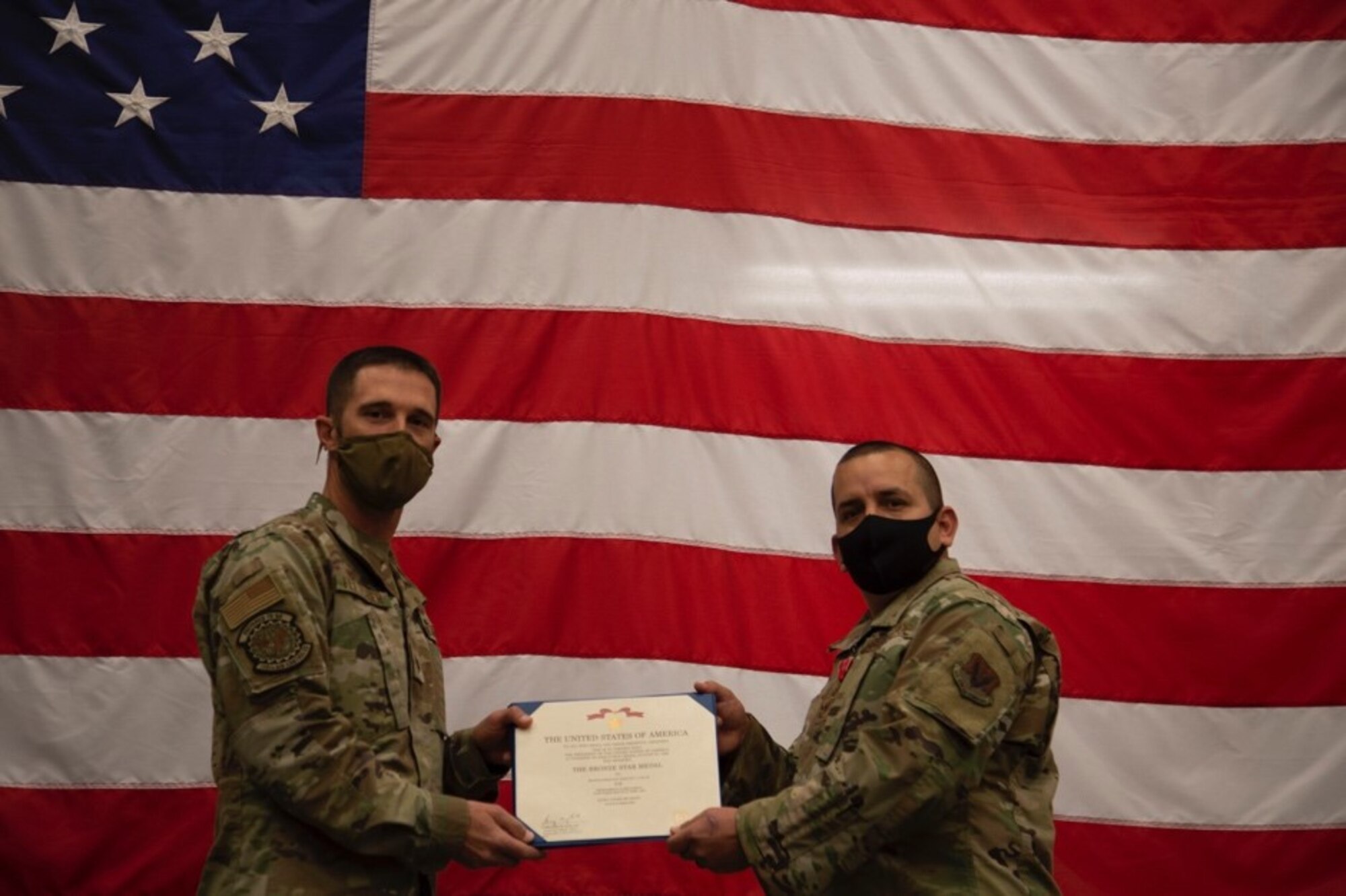 U.S. Air Force Lt. Col. Kevin Fletcher, 726th Air Control Squadron commander, presents the Bronze Star Medal to Master Sgt. Joe Rodriguez, 726th Air Control Squadron radio frequency transmissions systems NCOIC, at Mountain Home Air Force Base, Idaho, Oct. 9, 2020. Rodriquez served as the RF transmissions systems NCOIC at Al Asad Airbase, Iraq, from Oct. 9, 2019 to June 23, 2020. (U.S. Air Force Photo by Airman 1st Class Eric Brown)