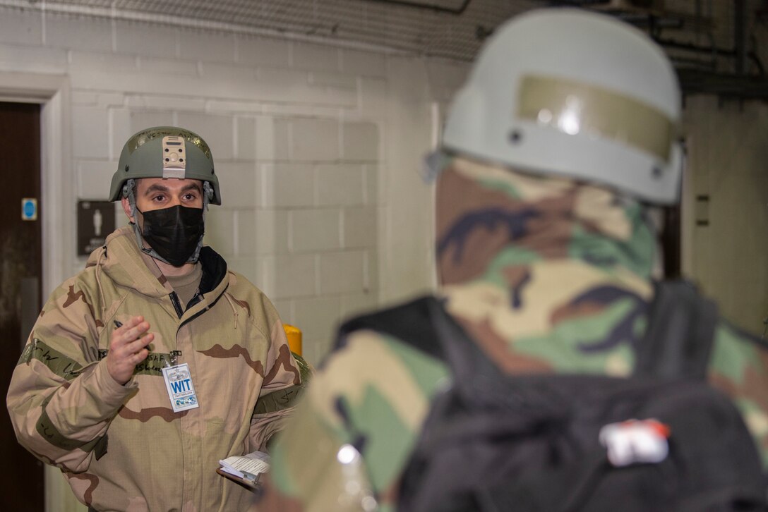 U.S. Air Force Tech. Sgt. Heston Ashlock, 727th Air Mobility Squadron wing inspection team member, gives feedback to an Airman during exercise Nodal Lightning at Royal Air Force Mildenhall, England, Oct. 21, 2020. The exercise integrated geographically separated units of the 521st Air Mobility Operations Wing, Ramstein Air Base, Germany, and tested the squadron’s readiness in a contested environment created through a simulated unmanned aerial vehicle attack. (U.S. Air Force photo by Airman 1st Class Joseph Barron)