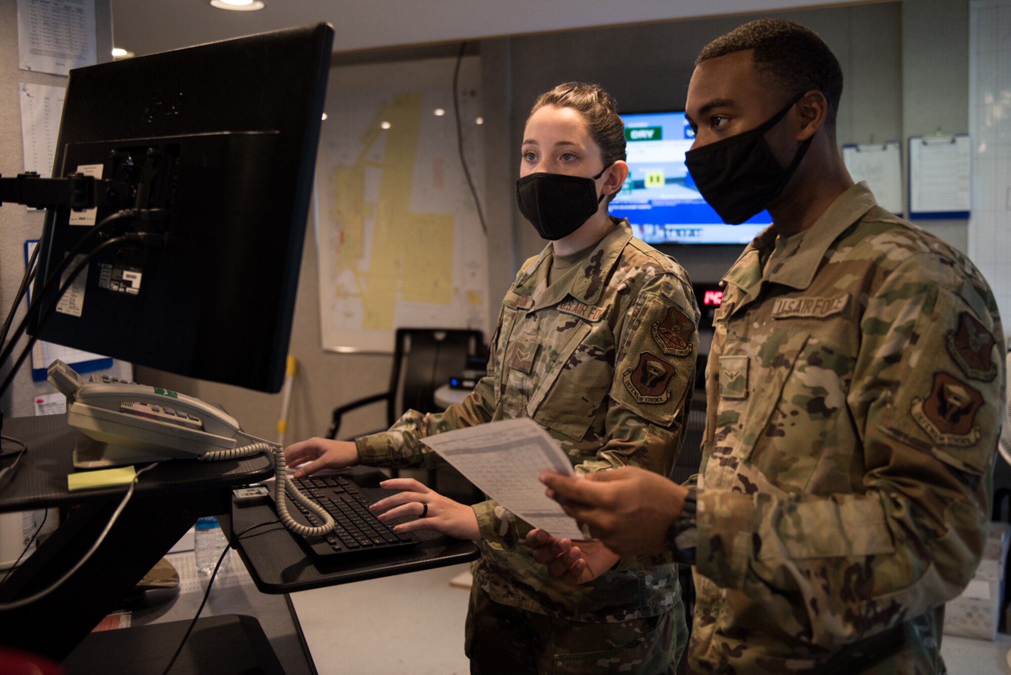 U.S. Air Force Airman 1st Class Enya Johnson and U.S. Air Force Airman Stephen Taborn-Walker, both 509th Operation Support Squadron Airfield Management operations coordinators, input a flight plan at Whiteman Air Force Base, Missouri, Sept. 23, 2020. Airfield management works with Air Traffic Control and other agencies to coordinate activities on the flight line. (U.S. Air Force photo by Airman 1st Class Christina Carter)