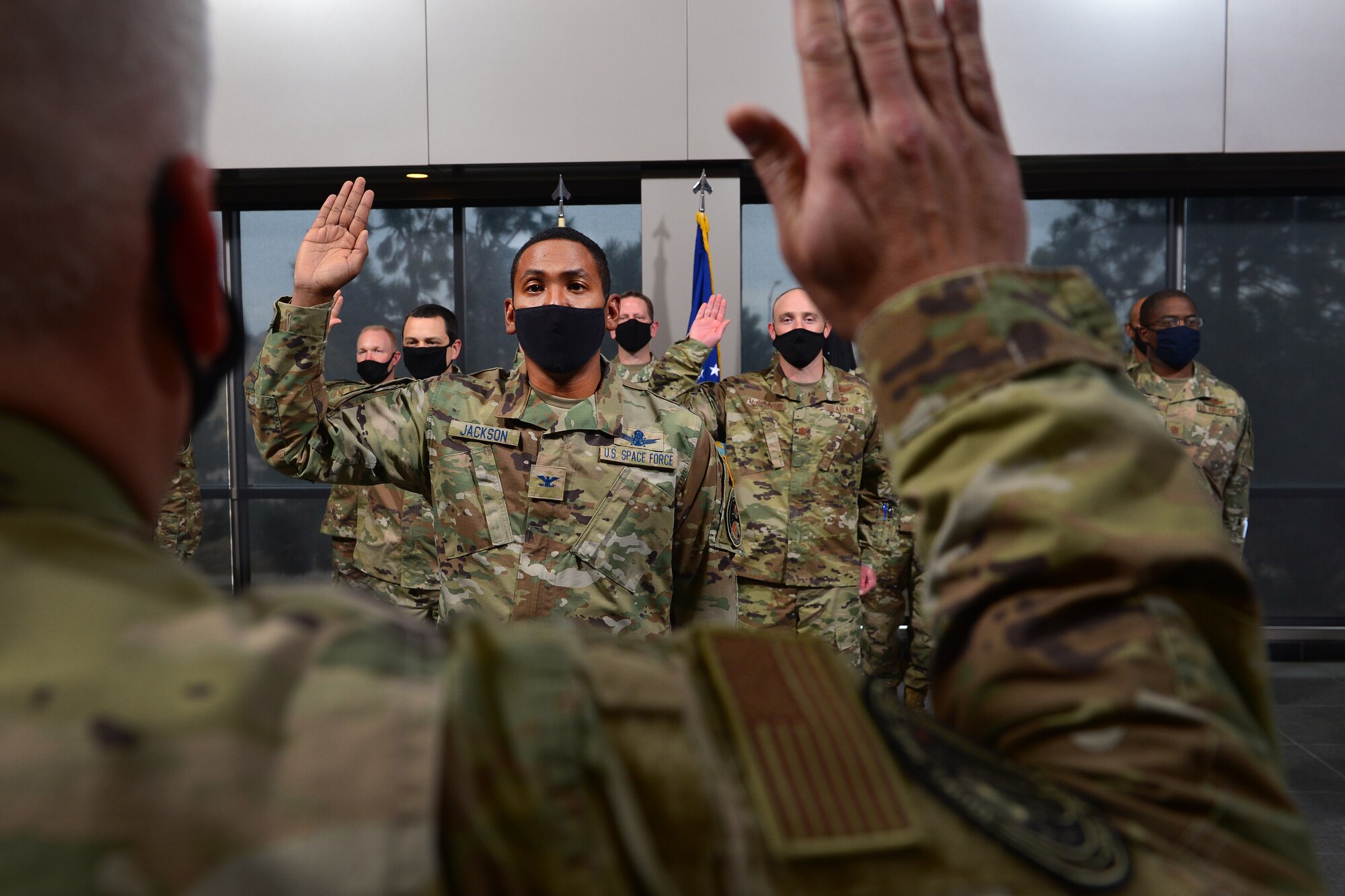 Col. Marcus Jackson, Joint Task Force - Space Defense (National Reconnaissance Office) deputy director, takes the Oath of Office during a transfer ceremony into the U.S. Space Force at Schriever Air Force Base, Colorado Oct. 23, 2020. Col. Scott Brodeur, JTF-SD director of operations, and Chief Master Sgt. Jacob Simmons, JTF-SD senior enlisted leader, hosted the ceremony. (U.S. Space Force Photo by Dennis Rogers)
