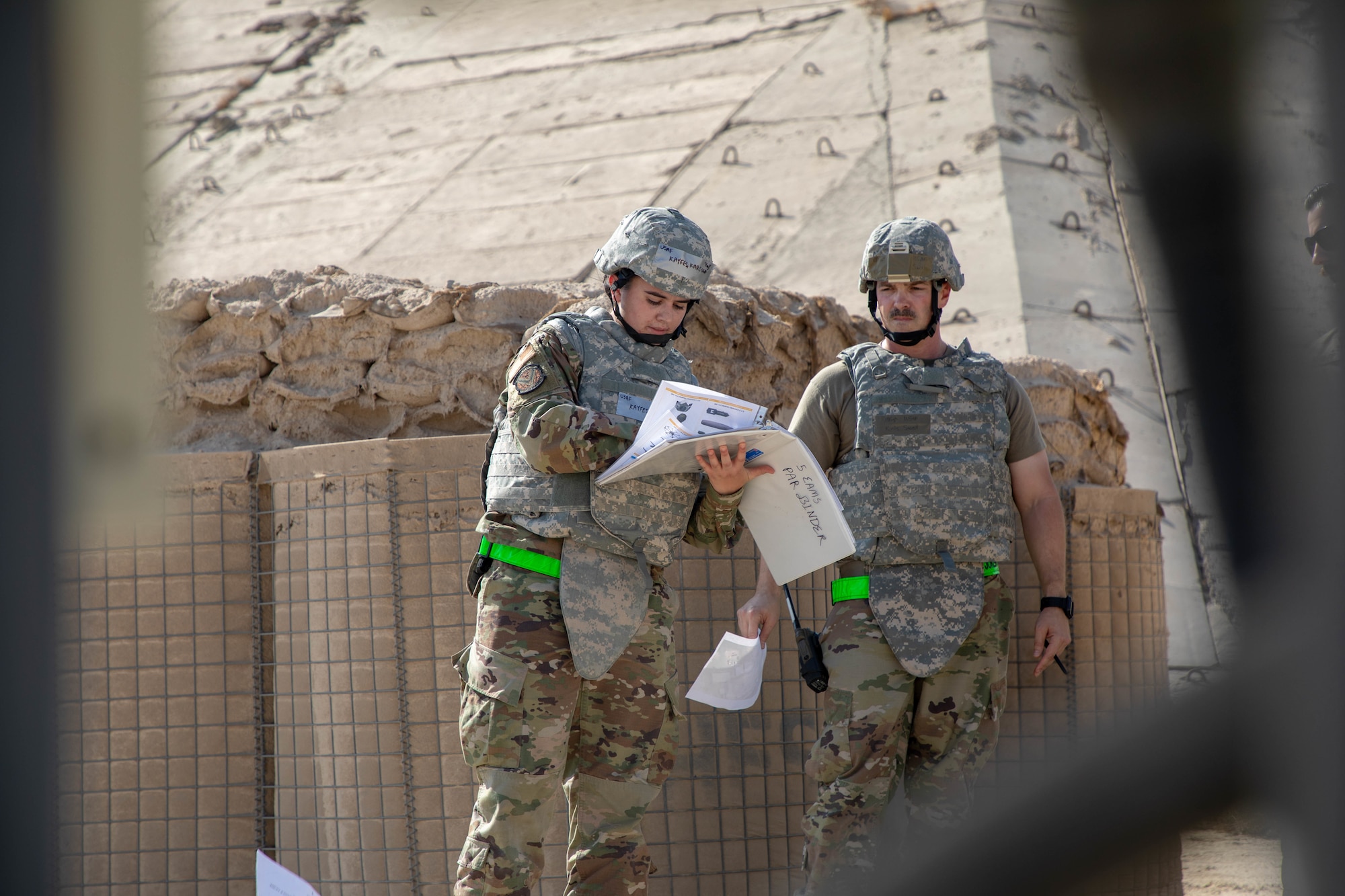 U.S. Air Force Staff Sgt. Karissa Kayfes, 5th Expeditionary Aircraft Maintenance Squadron supply airman, and Master Sgt. Kris Savell, 5th EAMS production superintendent, conduct a post-attack reconnaissance sweep during Exercise Nodal Lightning 20-2.