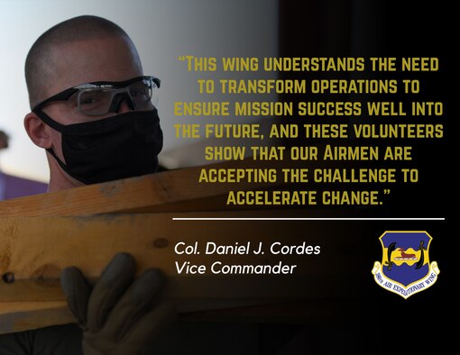 Demolition day volunteers place a table in a front end loader during a demolition day at Ali Al Salem Air Base, Kuwait, Oct. 21, 2020.