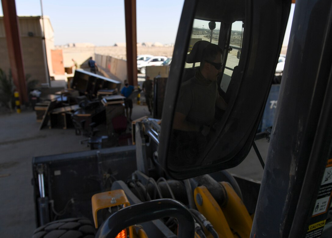 U.S. Air Force Senior Airman Mark Macias, 386th Expeditionary Civil Engineer Squadron heavy equipment operator, waits to pick up debris during a demolition day at Ali Al Salem Air Base, Kuwait, Oct. 21, 2020.