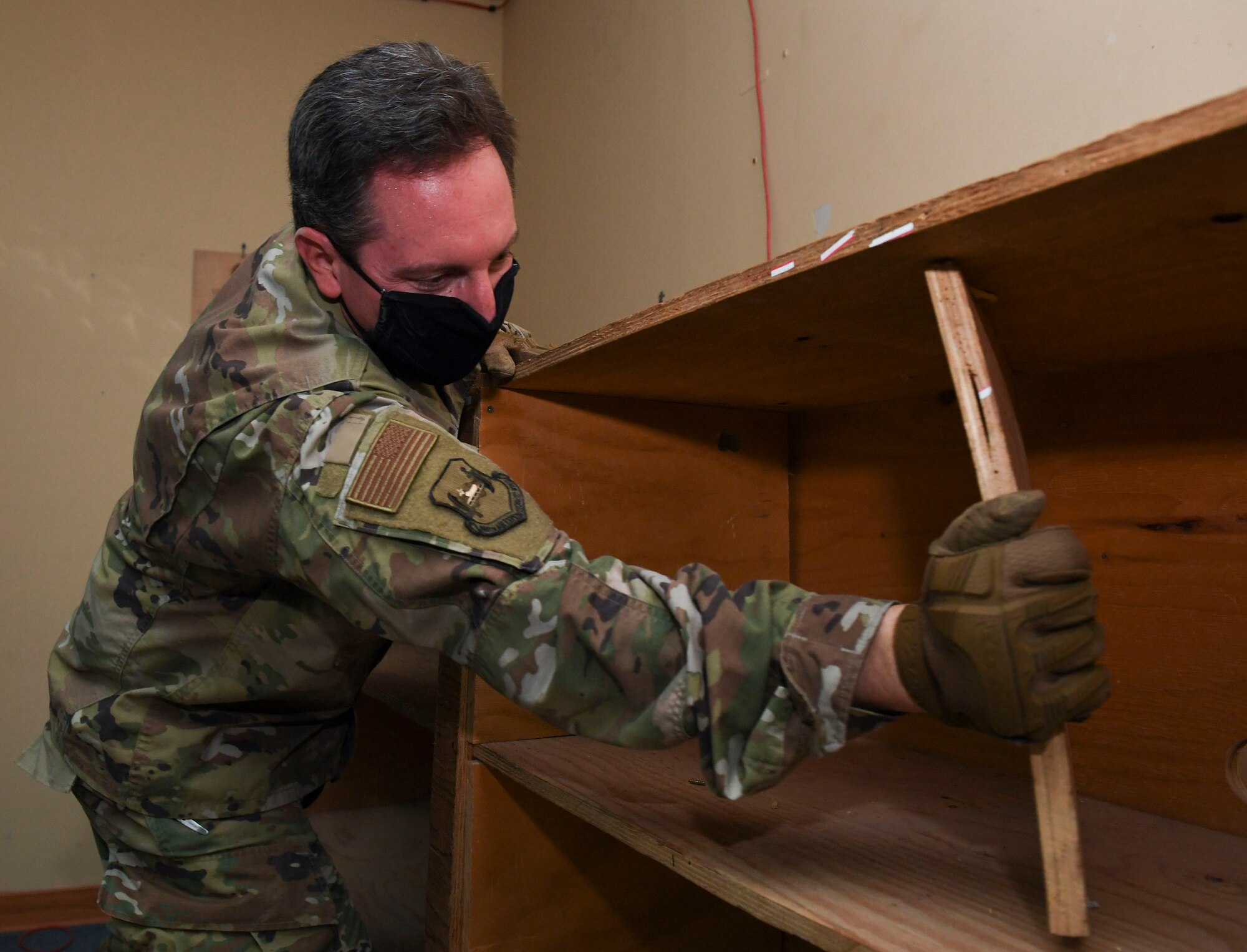 U.S. Air Force Lt. Col. John McMillen, 386th Air Expeditionary Wing director of staff, dismantles a shelf during a demolition day at Ali Al Salem Air Base, Kuwait, Oct. 21, 2020.