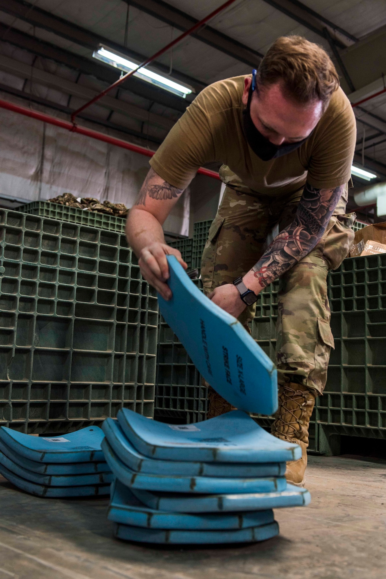 U.S. Air Force Senior Airman Collin Leger, 380th Expeditionary Logistics Readiness Squadron materiel management specialist, stacks ballistic plates at the individual protective equipment (IPE) warehouse on Al Dhafra Air Base, United Arab Emirates, Oct. 27, 2020.