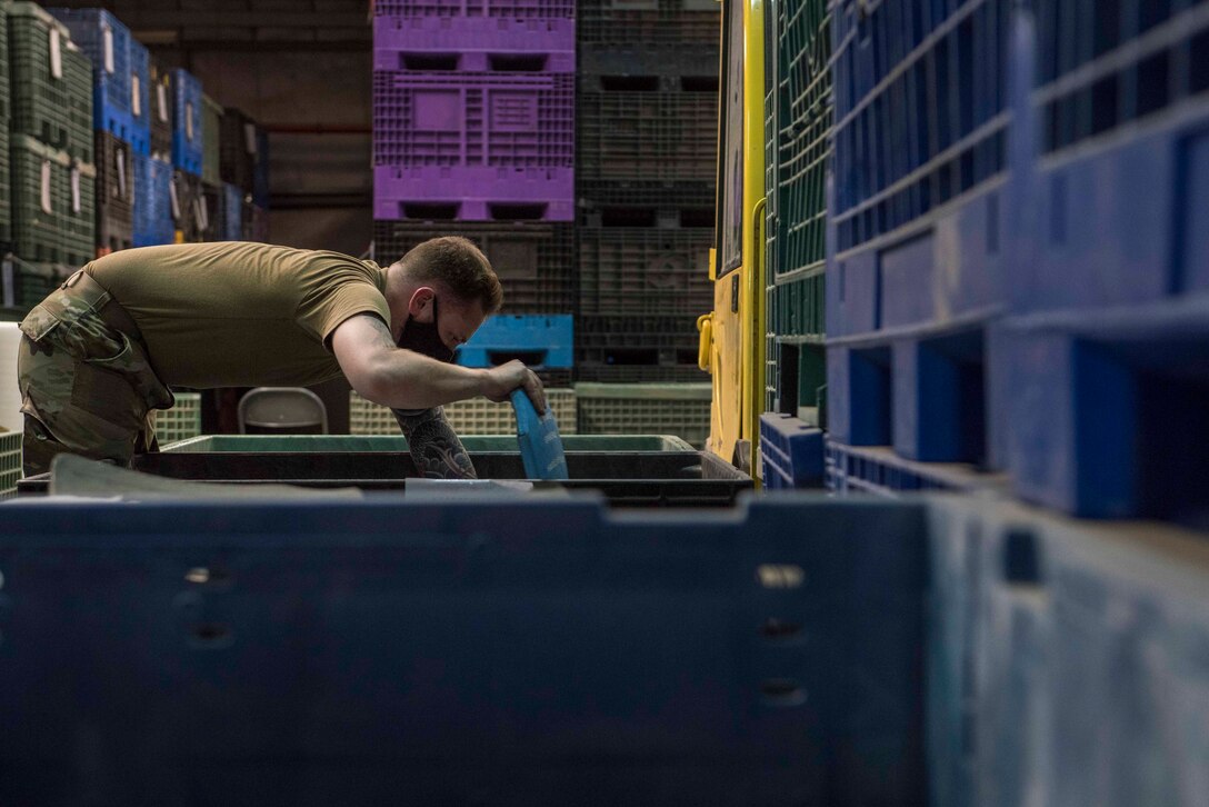 U.S. Air Force Senior Airman Collin Leger, 380th Expeditionary Logistics Readiness Squadron materiel management specialist, loads ballistic plates at the individual protective equipment (IPE) warehouse on Al Dhafra Air Base, United Arab Emirates, Oct. 27, 2020.