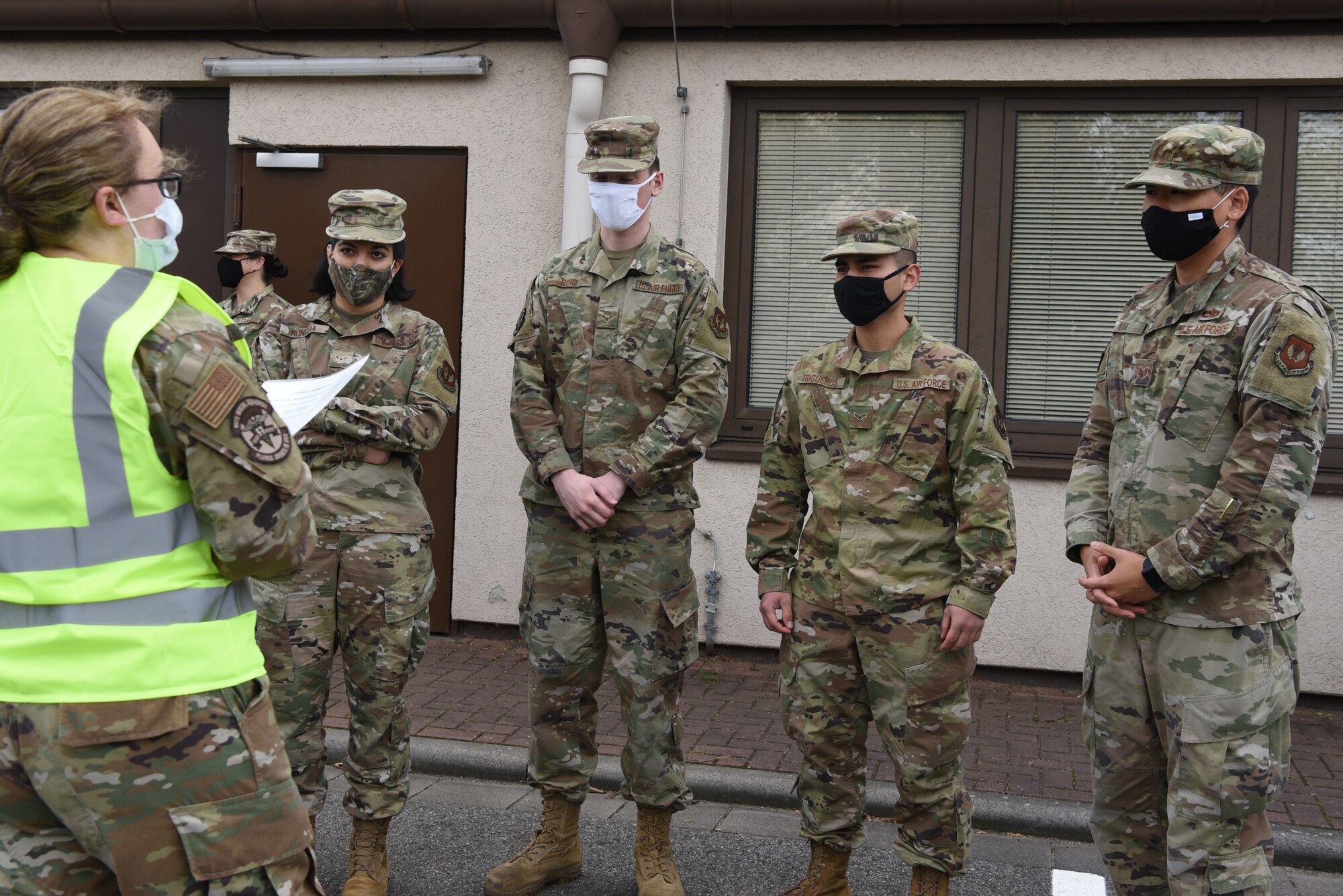 Ramstein Airmen receive a pre-screening brief prior to entering Hangar 3 for their flu vaccine at Ramstein Air Base, Germany, Oct. 27, 2020.