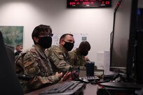 From the left, Col. Lisa Martinez, 341st Mission Support Group commander; Col. Nathan Mitchell, 341st Maintenance Group commander; and Col. Kenneth McGee, 341st Operations Group commander, are briefed at the Crisis Action Team as part of Global Thunder 21 Oct. 20, 2020, at Malmstrom Air Force Base, Mont. Global Thunder focuses on realistic training activities against simulated targets to ensure and improve nuclear readiness and strategic deterrent capabilities.