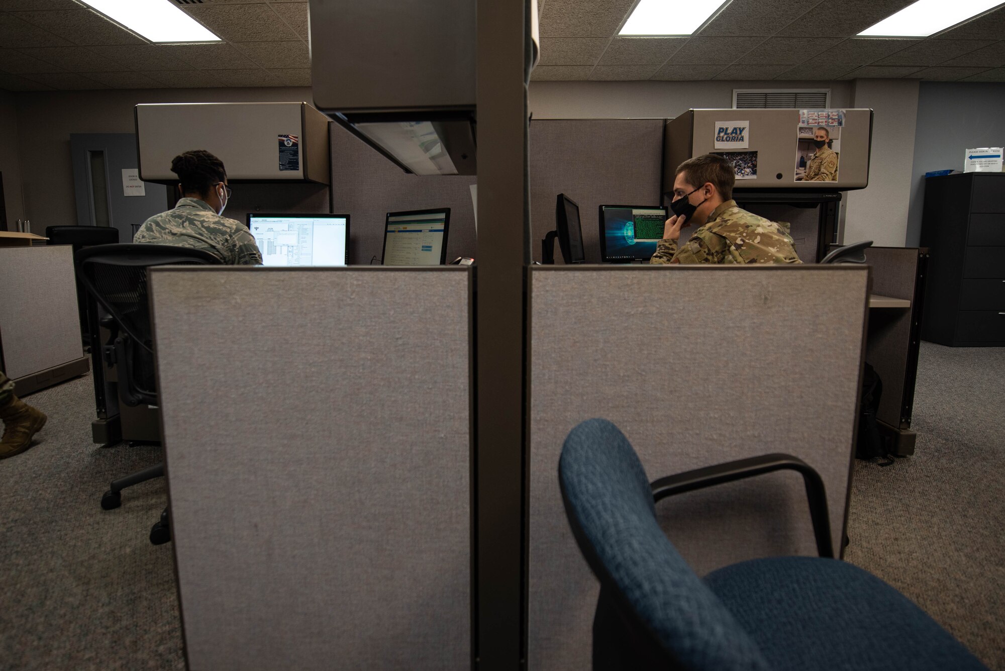 Airmen work in the office.