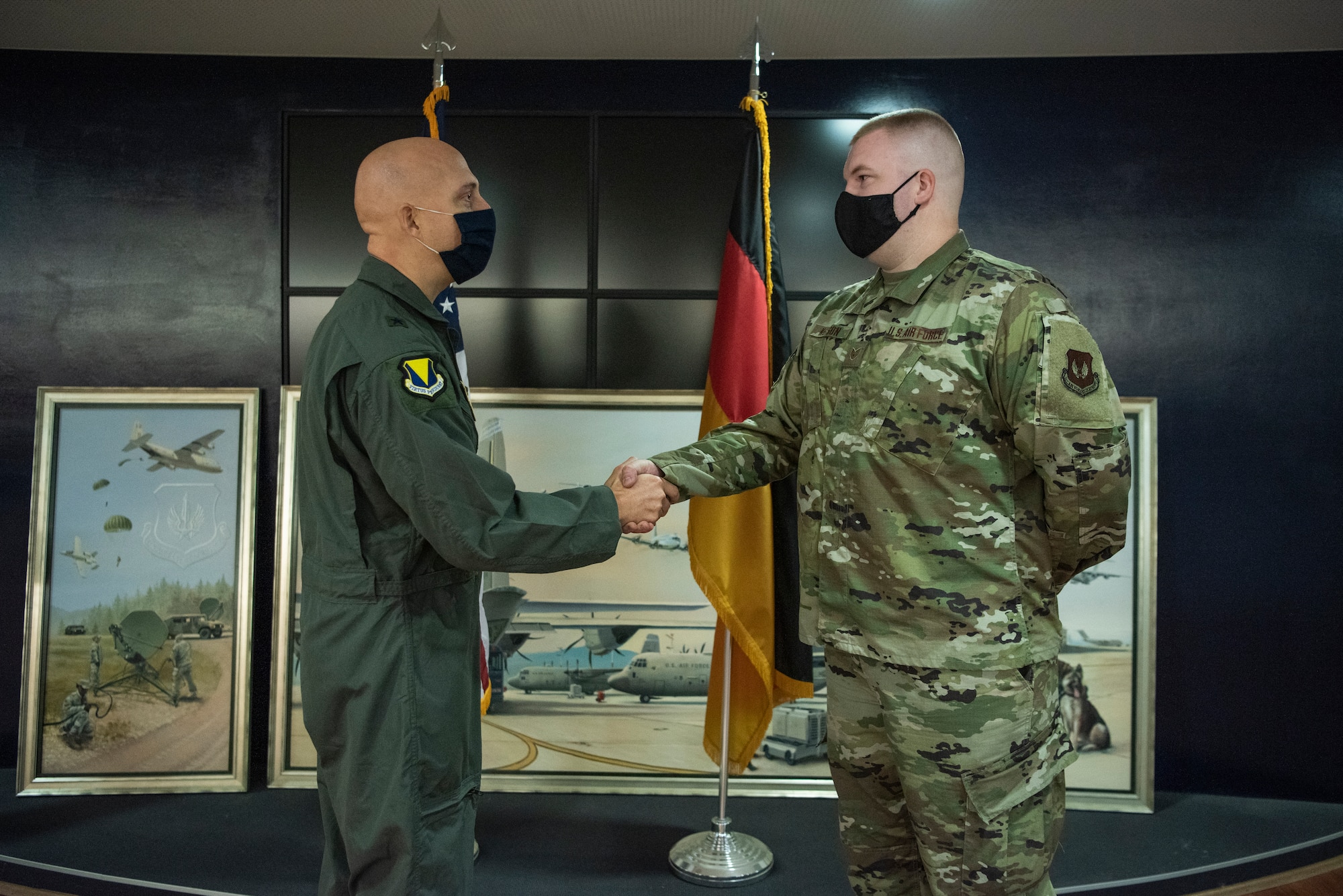 U.S. Air Force Staff Sgt. Tyler D. Nelson, 86th Maintenance Group maintenance operations center senior controller, receives a coin from Brig. Gen. Josh M. Olson, 86th Airlift Wing commander, at Ramstein Air Base, Germany, Oct. 23, 2020.