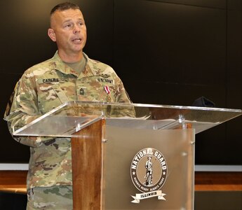 Master Sgt. Joshuah Carlile, of Bourbonnais, Illinois, addresses friends and family attending his retirement ceremony Sept. 12 at the Illinois Military Academy, Camp Lincoln, Springfield, Illinois.