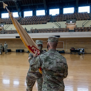 Col. Justin Osberg, Geneva, Illinois, hands the 108th Sustainment Brigade’s guidon to Maj. Gen. Richard Neely, the Adjutant General, Illinois National Guard, at the Northwest Armory, Chicago, Illinois, Sept. 12
