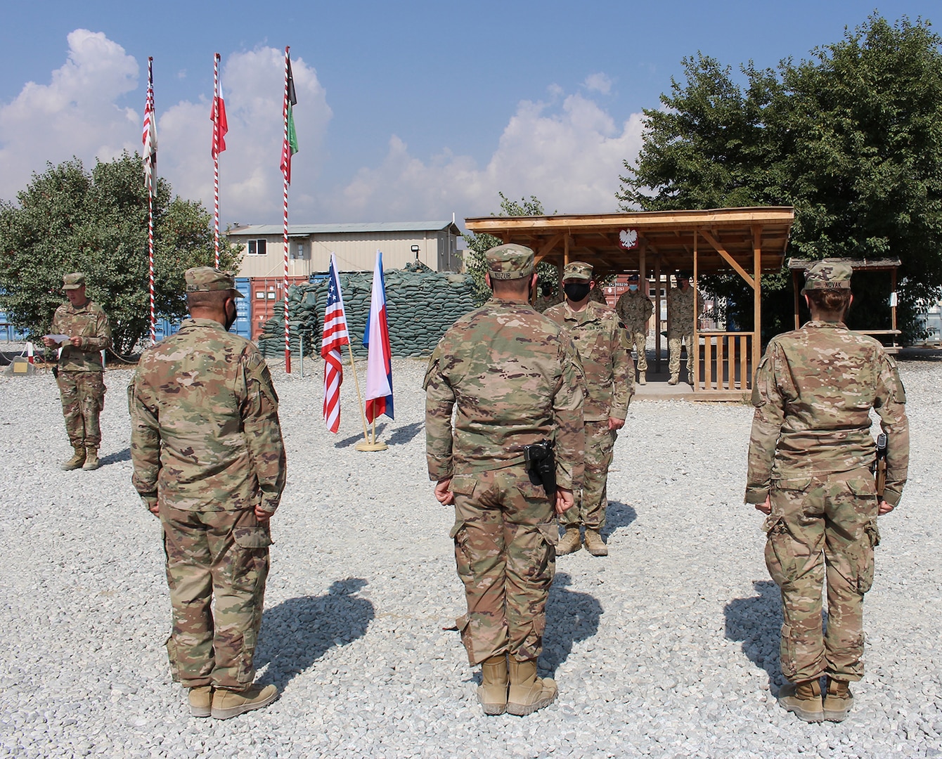 Lt. Col. Jason Osberg, of Champaign, Illinois, Commander, Bilateral Embedded Staff Team A25, addresses Illinois Army National Guard Soldiers during the recent patching ceremony held at the Polish Military Compound at Bagram Airfield, Afghanistan.