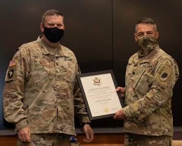 Lt. Col. Jeffary Jiannoni, of Petersburg, Illinois, accepts the Certificate of Retirement from Col. Leonard Williams, of Dyer, Indiana, Chief of Staff, Illinois Army National Guard, during Jiannoni’s retirement ceremony Oct. 8 at the Illinois Military Academy, Camp Lincoln, Springfield, Illinois.