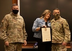 Angie Jiannoni, wife of Lt. Col. Jeffary Jiannoni, of Petersburg, Illinois, accepts a Certificate of Appreciation from Col. Leonard Williams, of Dyer, Indiana, Chief of Staff, Illinois Army National Guard, during Jiannoni’s retirement ceremony Oct. 8 at the Illinois Military Academy, Camp Lincoln, Springfield, Illinois.
