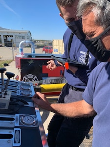 Firefighters Michael Budke and Craig Behrens, 155th Civil Engineering Squadron, run through a realistic fire scenario on a pump operations simulator Oct. 15, 2020, at Nebraska National Guard airbase in Lincoln, Nebraska. The squadron bought the simulator with the aid of U.S. Air Force innovation funds.