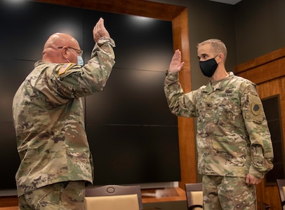 Newly promoted Col. Kevin G. Little, of Franklin, Illinois, recites the oath of commissioned officers