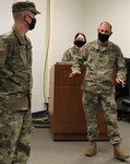 Newly promoted Sgt. Timothy Gronewold, of Forreston, Illinois, is congratulated by Col. Daniel Reichen, of Springfield, Illinois, Commander, 129th Regiment (Regional Training Institute) during Gronewold’s promotion ceremony Oct. 18 at Camp Lincoln, Springfield, Illinois.