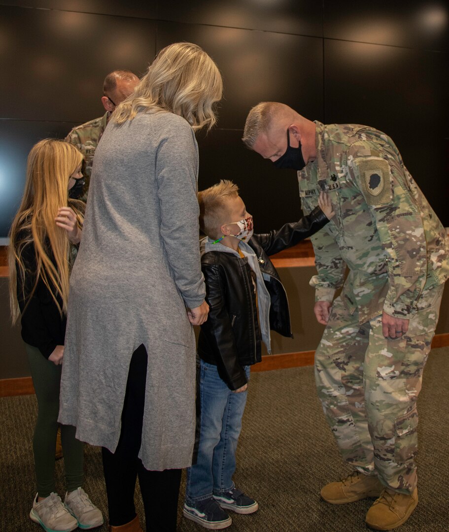 Illinois Army National Guard Master Sgt. Clint Murphy, of Athens, Illinois, receives his First Sergeant rank from son, Van, daughter, Dylan, and wife, Jessica, during a pinning ceremony Oct. 23 at the Illinois Military Academy, Camp Lincoln, Springfield, Illinois
