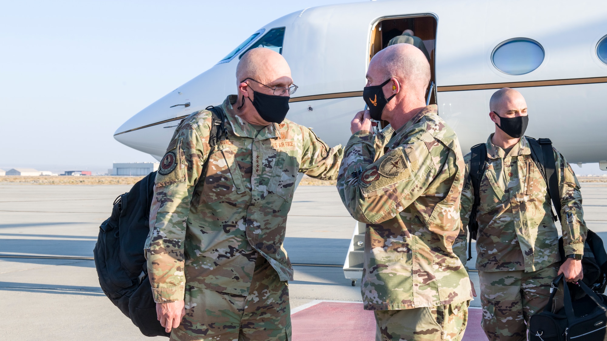 Gen. Arnold W. Bunch, Jr., commander of Air Force Materiel Command, converses with Maj. Gen. Christopher Azzano, Air Force Test Center commander, as he arrives at Edwards Air Force Base, California, Oct. 23. (Air Force photo by Giancarlo Casem)