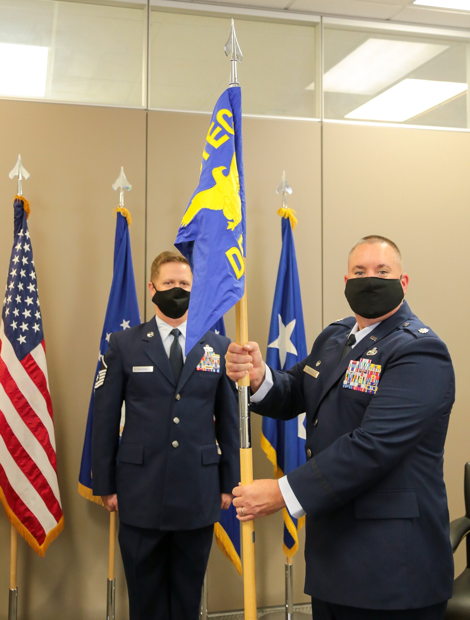 Lt. Col. Jeremy Russell holds the Air Force Operational Test and Evaluation Center Detachment 3 guidon.
