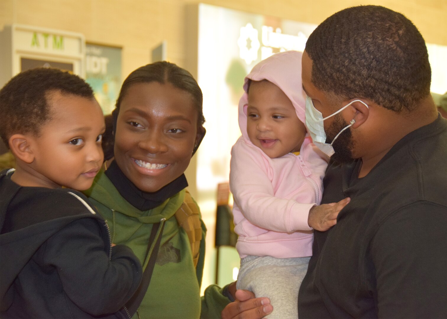 Senior Airman Deonna N. Brown, 433rd Security Forces Squadron, is greeted by her husband Coy Brown and their two children Levi and Madison Oct. 26, 2020 at the San Antonio International Airport. Brown’s husband surprised her as she walked out to the baggage claim. (U.S. Air Force photo by Tech. Sgt. Iram Carmona)