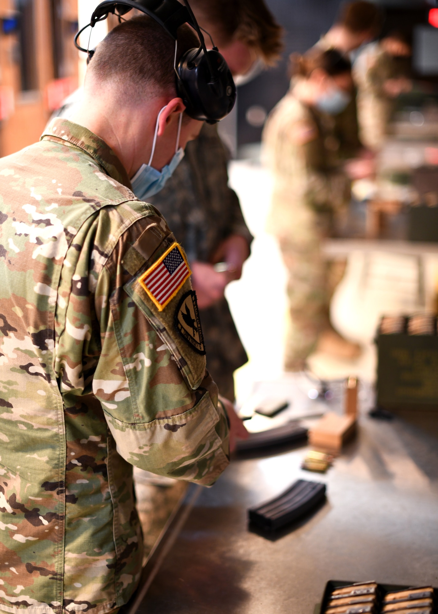 Cadet Hunter Brown, University of North Dakota Army Reserve Officer Training Corps cadet commander helps load an M4A1 carbine magazine during weapons familiarization training on Grand Forks Air Force Base, N.D., Oct. 24, 2020. The 319th Security Forces Squadron supplied the cadets with ammunition and indoor range access while the primary ROTC firing rage on Camp Grafton undergoes maintenance. (U.S. Air Force photo by Staff Sgt. Patrick A. Wyatt