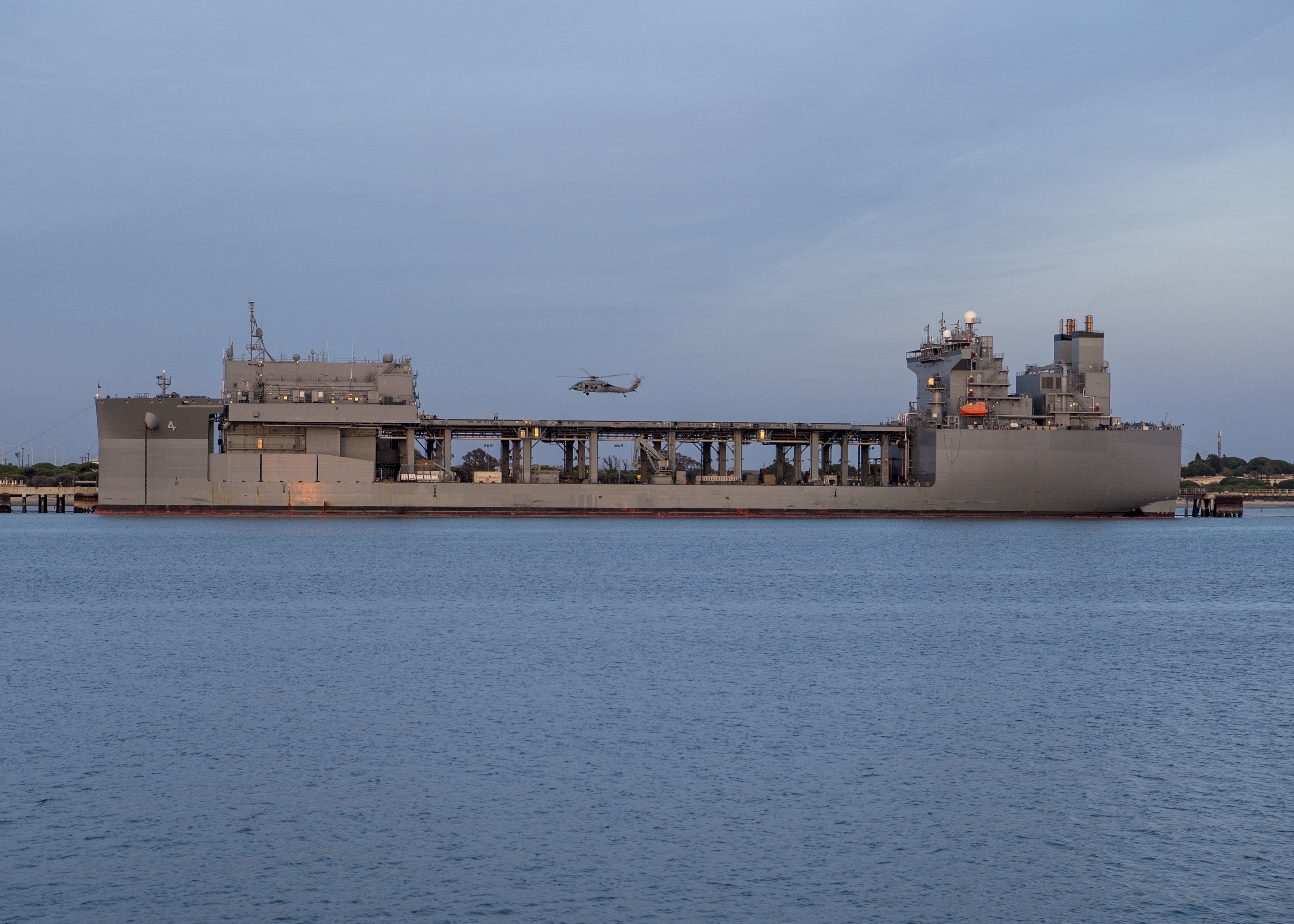 An MH-60S Sea Hawk helicopter attached to Helicopter Sea Combat Squadron (HSC) 28 takes off from the flight deck of the expeditionary sea base USS Hershel "Woody" Williams (ESB 4) at Naval Station Rota, Spain,