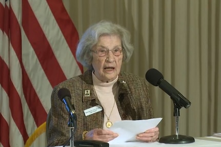 A woman speaks into a microphone.