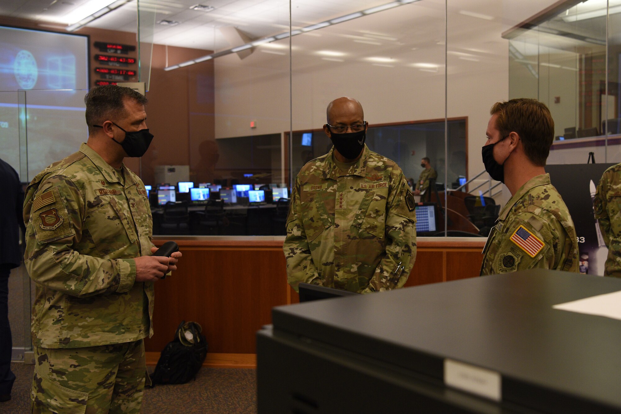 U.S Air Force Chief of Staff Gen. Charles Q. Brown, Jr., speaks with Col. Anthony Mastalir, 30th Space Wing commander, and Lt. Col. Sean Ianacone, 2nd Range Operations Squadron commander, during a tour of the Western Range Operations Control Center Oct. 27, 2020, at Vandenberg Air Force Base, Calif.