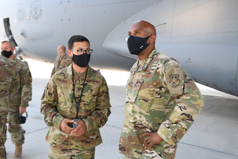 U.S. Air Force Staff Sgt. Anothy Pellegrini, assigned to the 8th Expeditionary Air Mobility Squadron, guides the 379th Air Expeditionary Wing Command Chief, Chief Master Sgt. Kenneth Bruce, through a tour of an exposed C-17 Globemaster engine Oct. 23, 2020, at Al Udeid Air Base, Qatar. The Airmen of The Mighty Ocho are responsible for transporting an average of 10 million pounds of cargo and 5,000 passengers throughout the U.S. Central Command area of responsibility each month, accounting for more than 36 percent of airlift operations in Europe and Southwest Asia. (U.S. Air Force photo by Staff Sgt. Kayla White) (Photo altered to obscure identification badges for operational security)