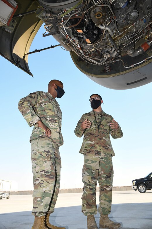 U.S. Air Force Staff Sgt. Anothy Pellegrini, assigned to the 8th Expeditionary Air Mobility Squadron, guides the 379th Air Expeditionary Wing Command Chief, Chief Master Sgt. Kenneth Bruce, through a tour of an exposed C-17 Globemaster engine on Oct. 23, 2020, at Al Udeid Air Base, Qatar. The Airmen of The Mighty Ocho are responsible for transporting an average of 10 million pounds of cargo and 5 thousand passengers throughout the U.S. Central Command area of responsibility each month, accounting for more than 36 percent of airlift operations in Europe and Southwest Asia. (U.S. Air Force photo by Staff Sgt. Kayla White)