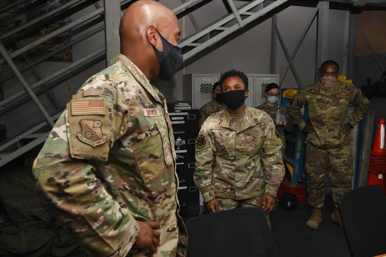 U.S. Air Force Staff Sgt. Shanita Davies. assigned to the 8th Expeditionary Air Mobility Squadron at Al Udeid Air Base, Qatar, guides the 379th Air Expeditionary Wing Command Chief, Chief Master Sgt. Kenneth Bruce, through her section of the 8th EAMS work center on Oct. 23, 2020. The Airmen of The Mighty Ocho are responsible for transporting an average of 10 million pounds of cargo and 5 thousand passengers throughout the U.S. Central Command area of responsibility each month, accounting for more than 36 percent of airlift operations in Europe and Southwest Asia. (U.S. Air Force photo by Staff Sgt. Kayla White)