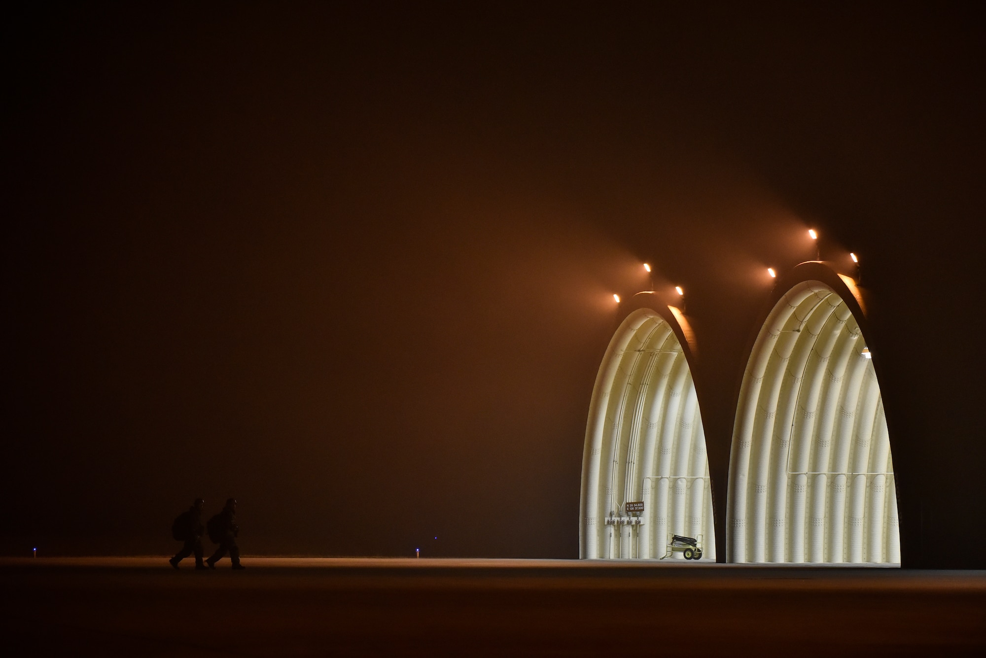 Airmen walking on the flightline.